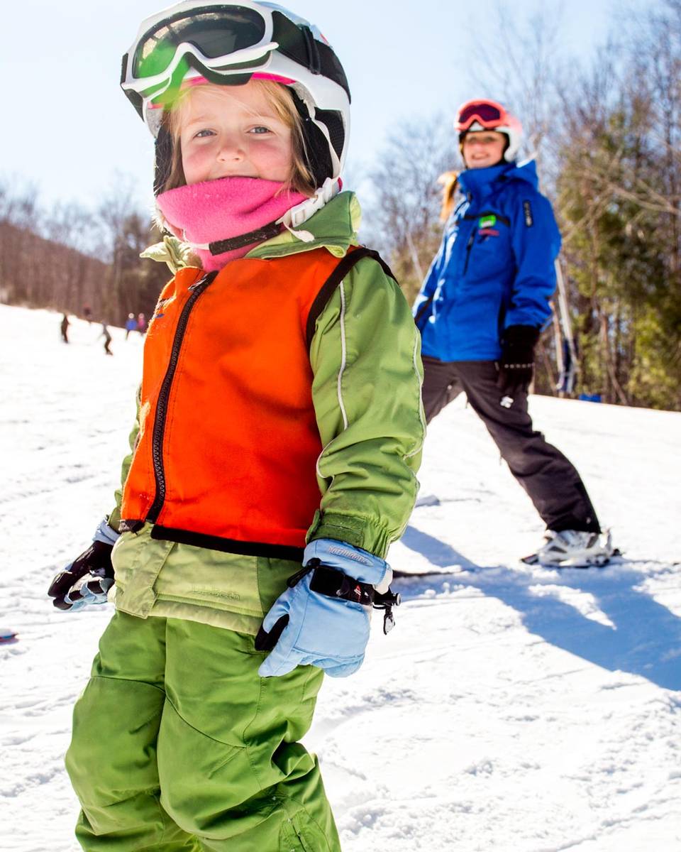 child with ski instructor