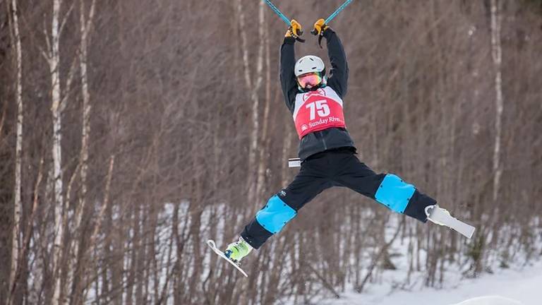 young freestyle skier in bumps course