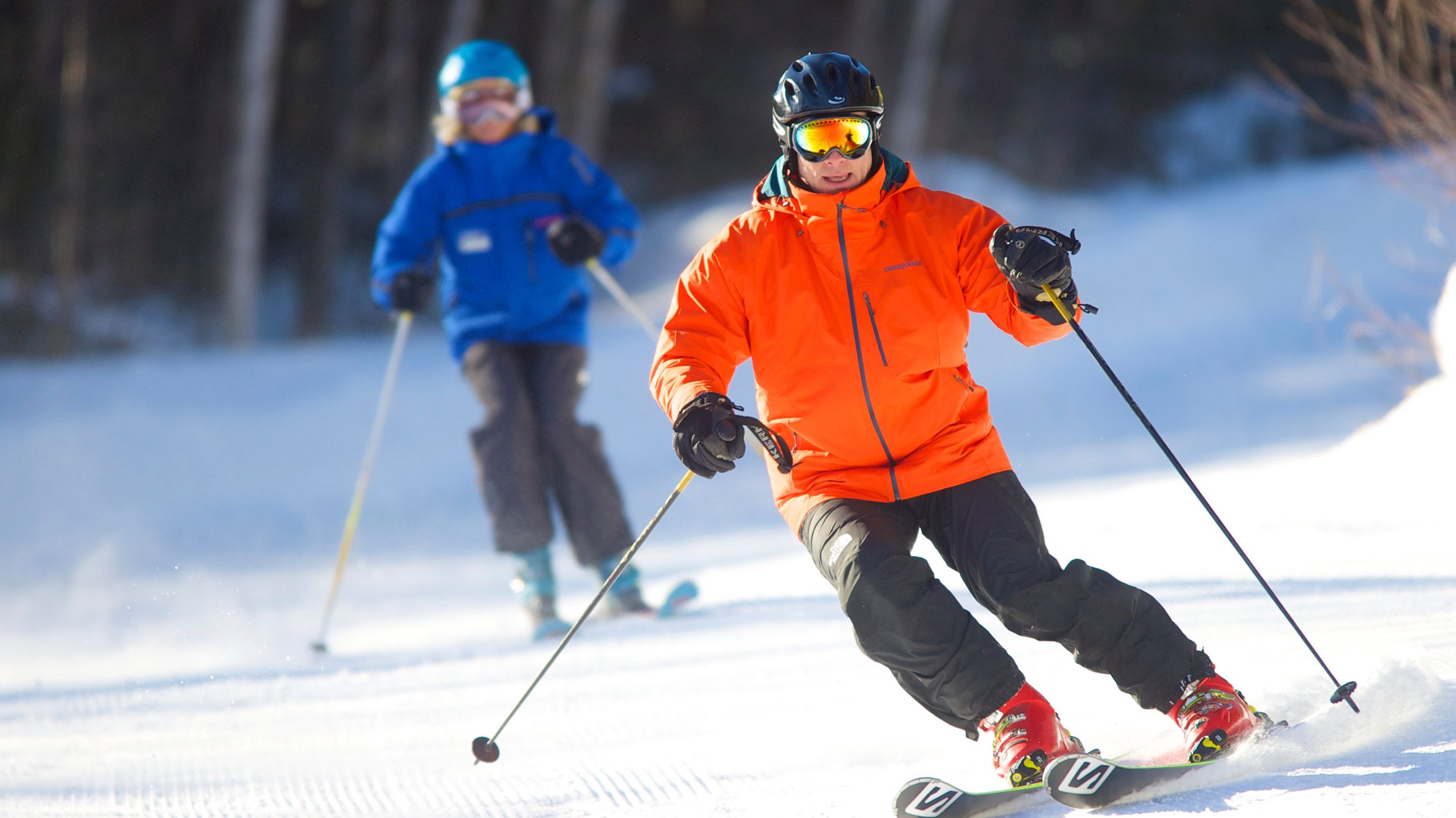 Adult male and instructor skiing at Loon Mountain Resort