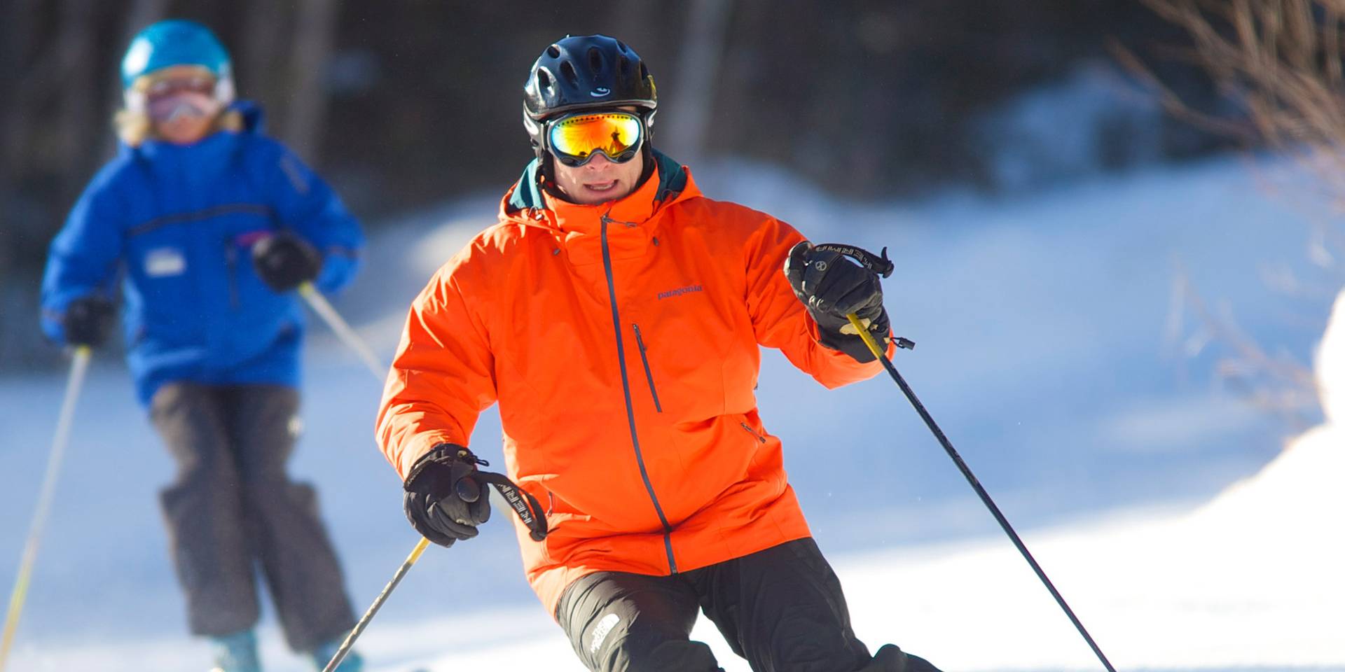 Adult male and instructor skiing at Loon Mountain Resort