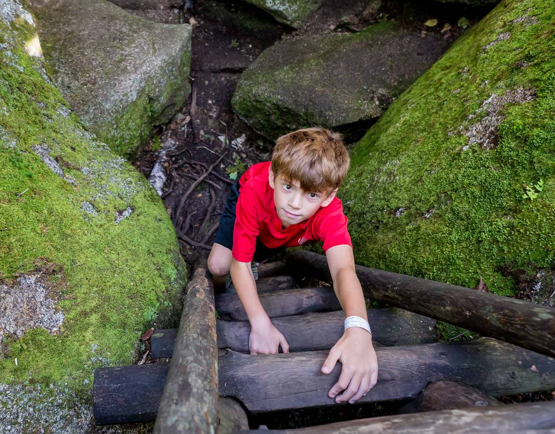 young rider on technical downhill mountain bike trail