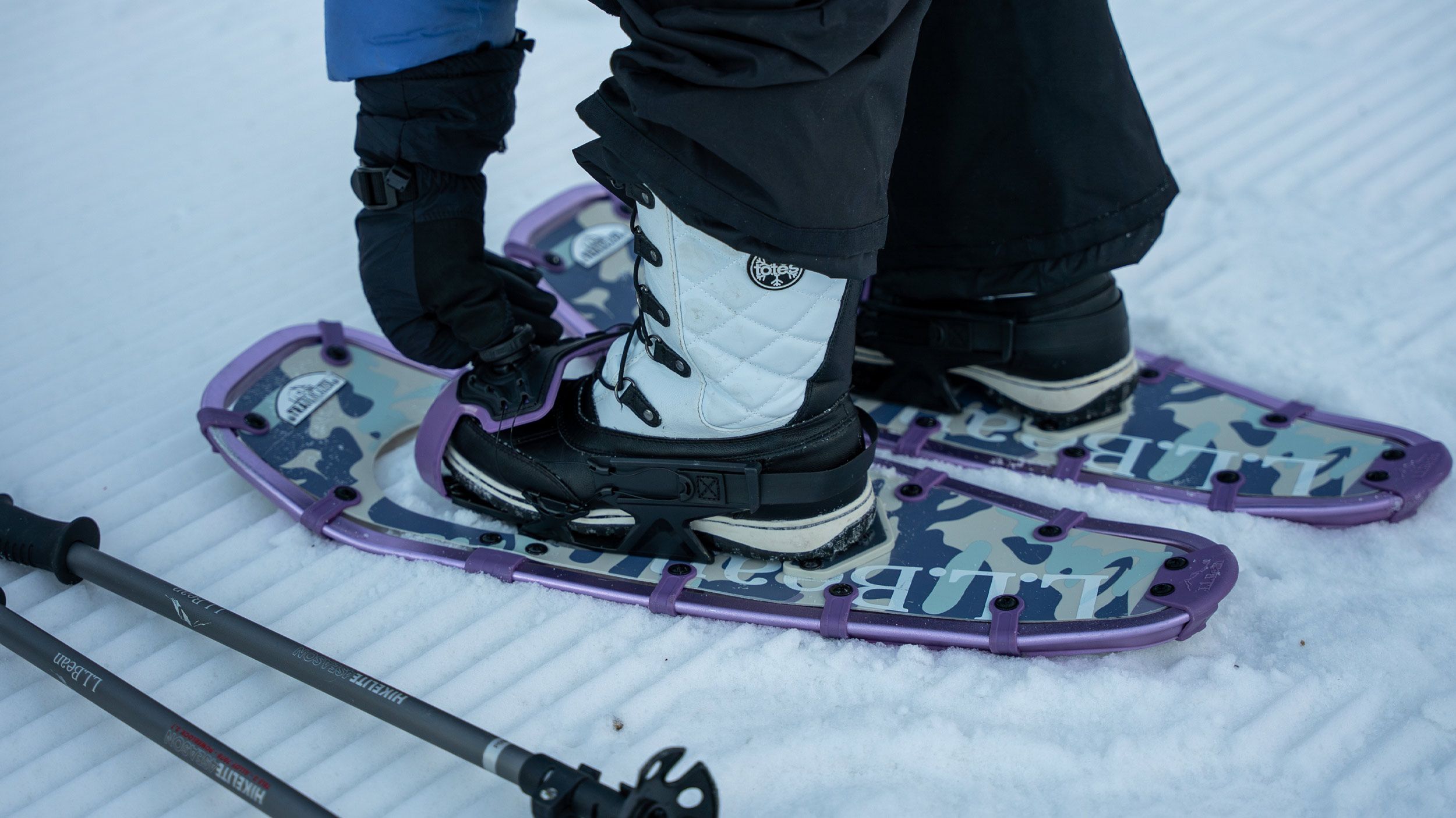 Person putting on Snowshoes