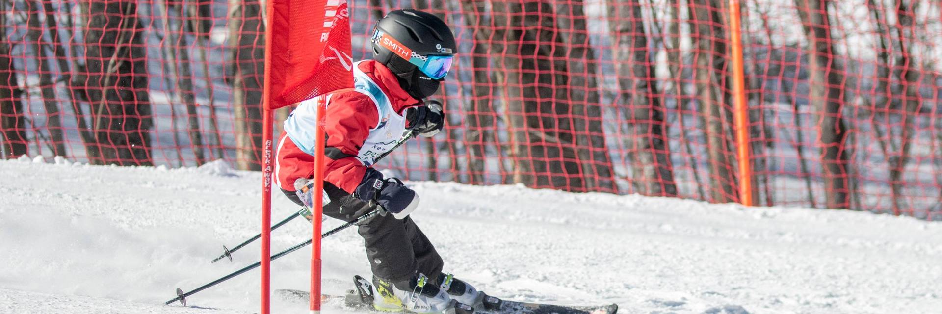 Little boy racing through a gate