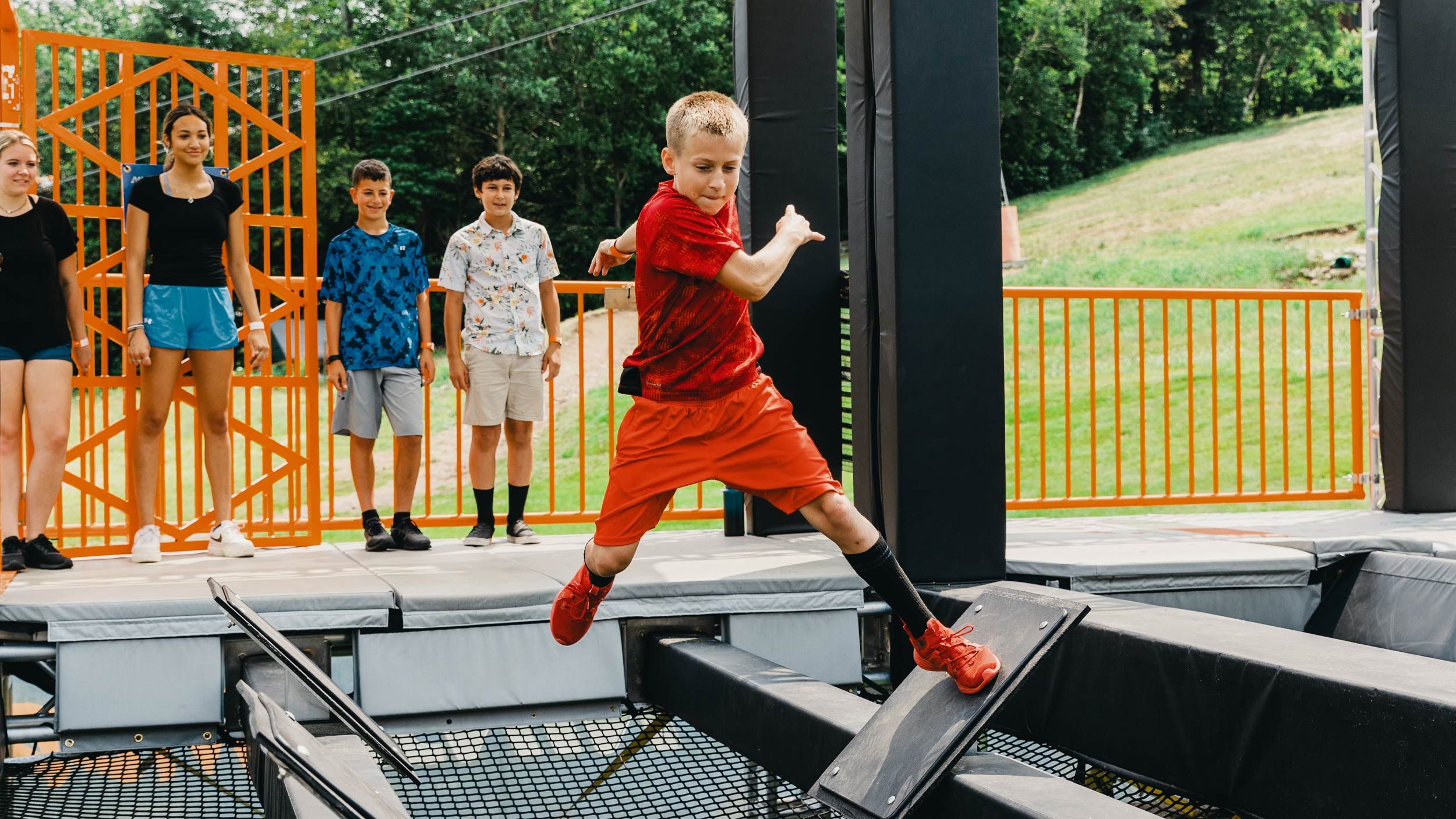 young boy navigating the obstacles in the Ninja Wild course