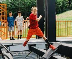 young boy navigating the obstacles in the Ninja Wild course