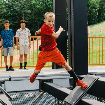 young boy navigating the obstacles in the Ninja Wild course
