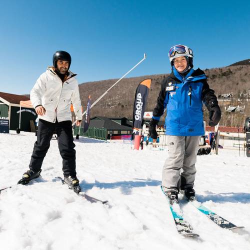 skier and instructor on beginner terrain