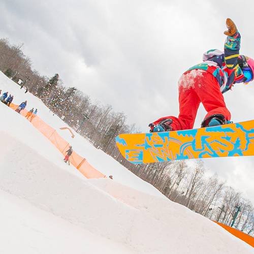 Young snowboarder going off jump at Loon Mountain