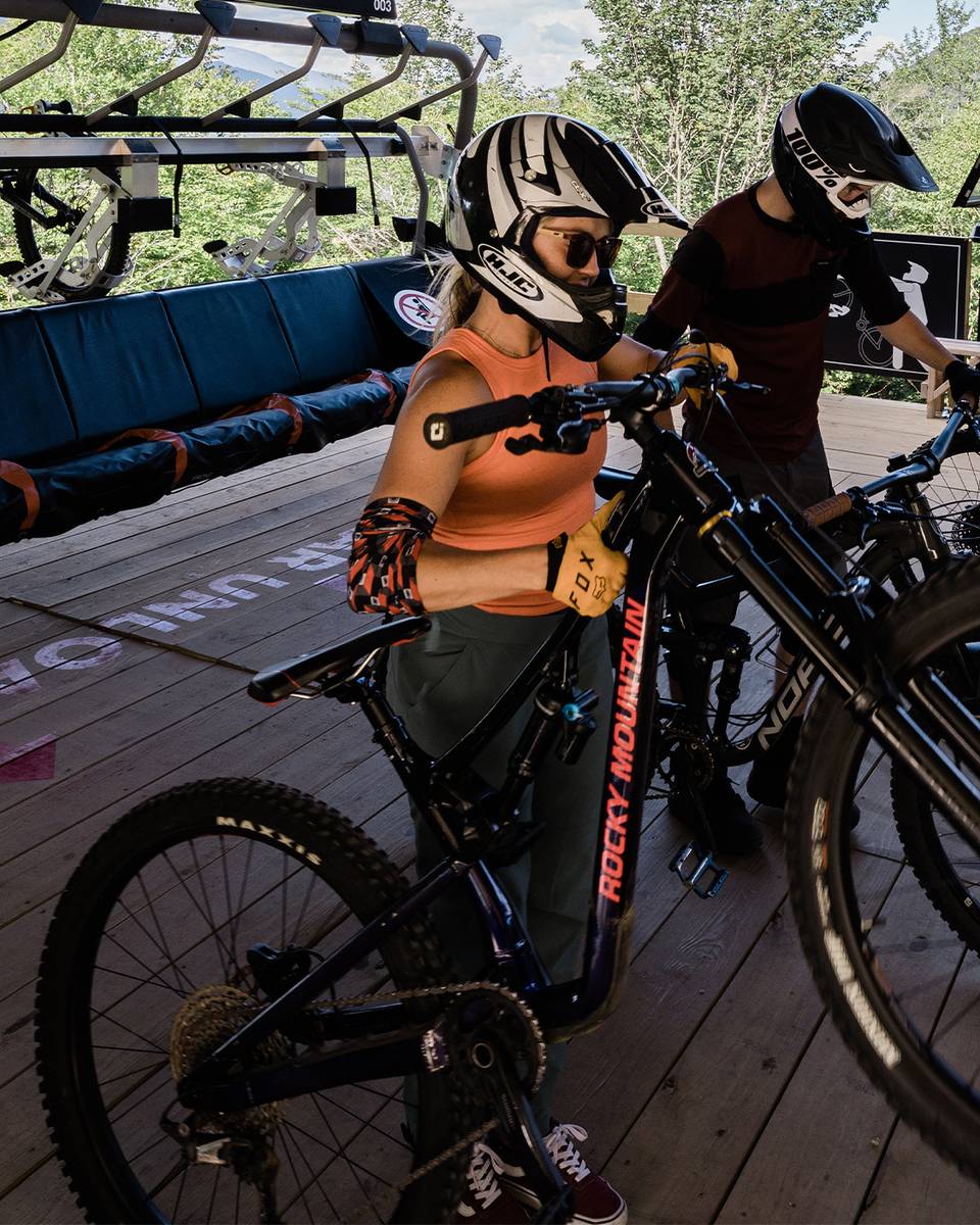 female biker unloading bike off Kancamagus 8