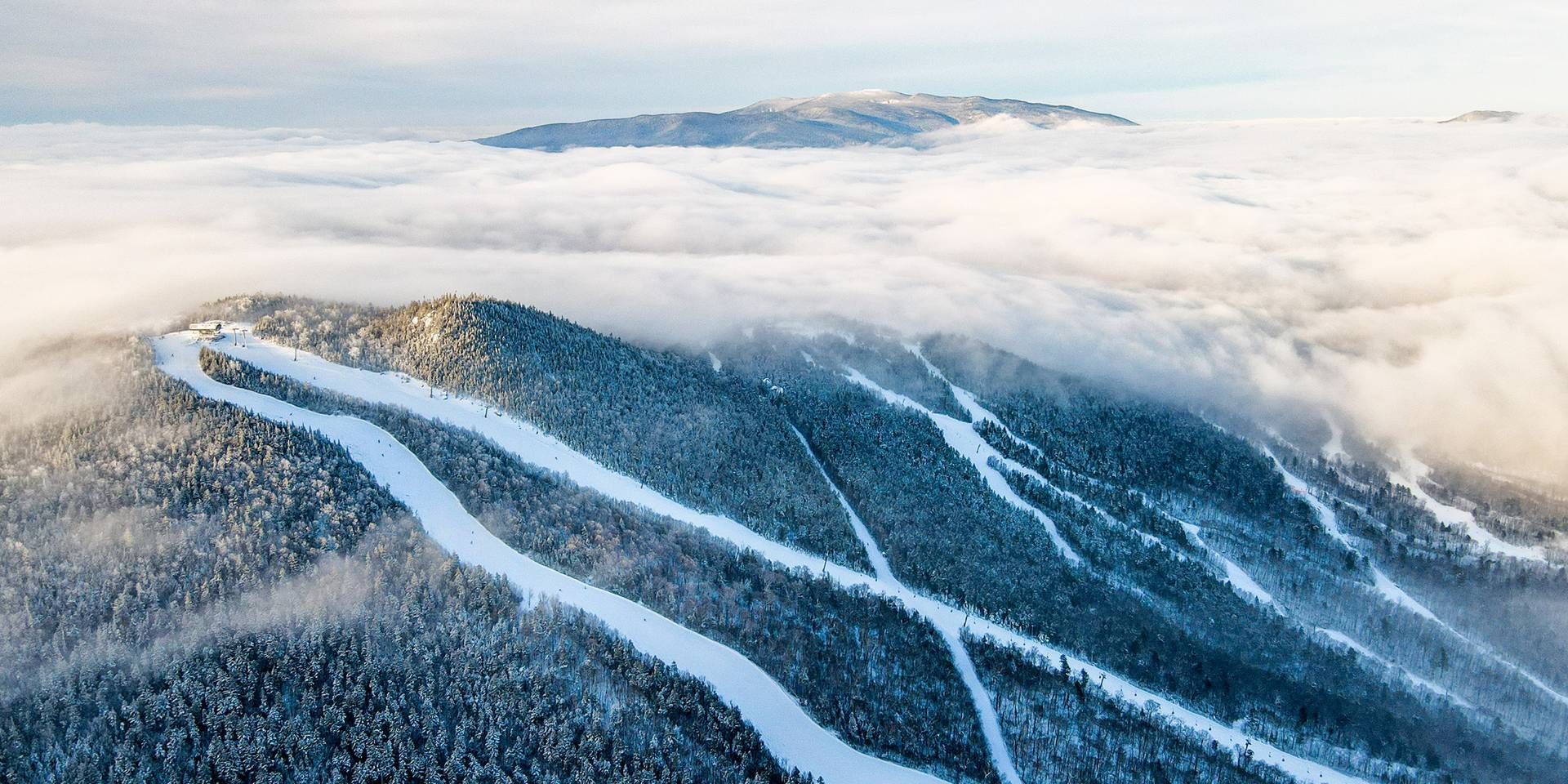 winter drone shot of Loon, with the peak shrouded in clouds