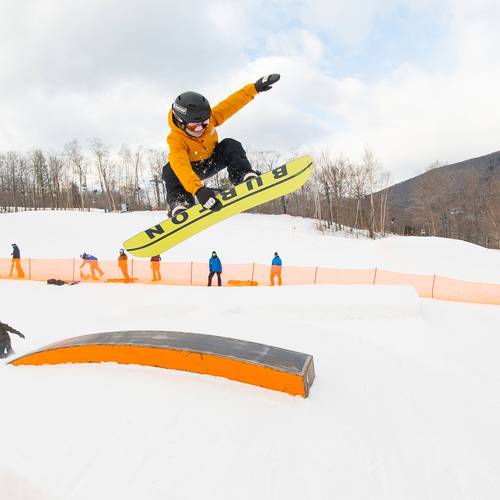 Young snowboarder performing a grab