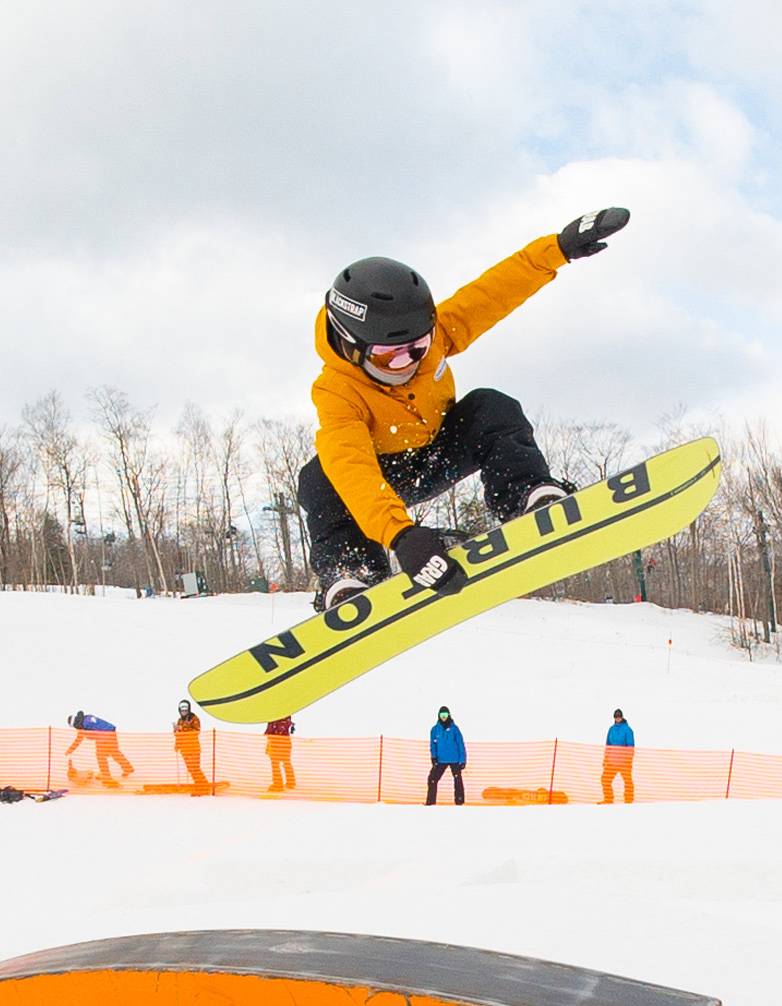 young snowboarder performing a grab