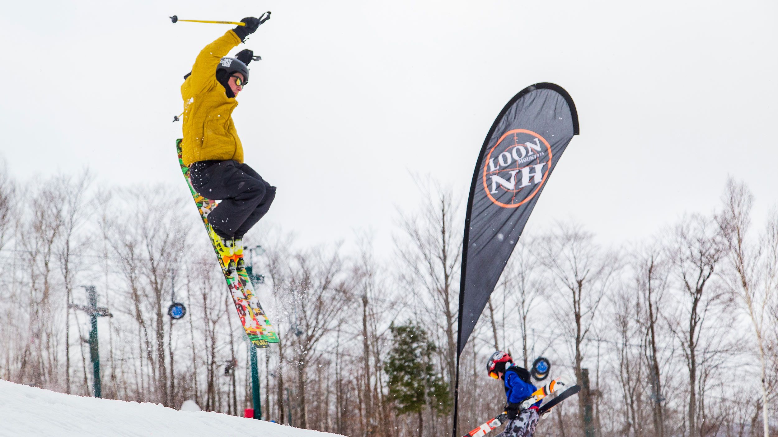 young teen freeskier going off a park element