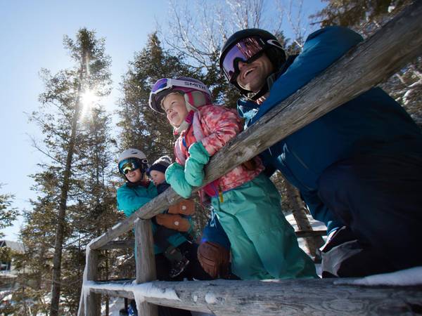 Family in the winter overlooking ski trails