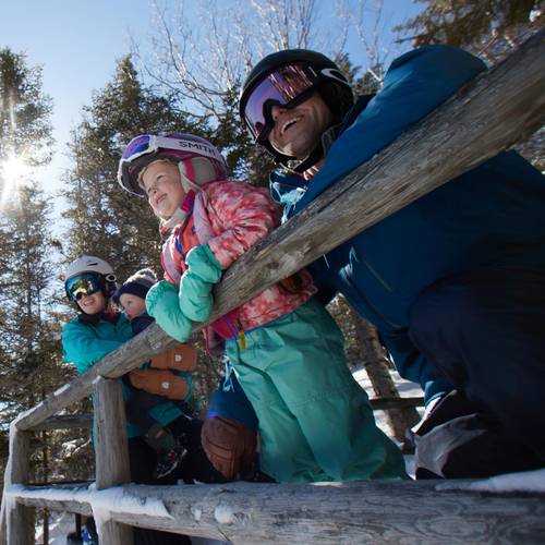 Mother, father and two kids looking at the winter scenery at Loon Mountain