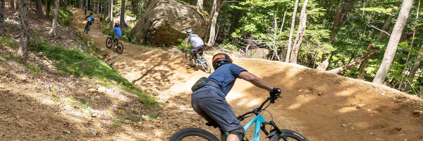 Bikers going down a mountain bike trail