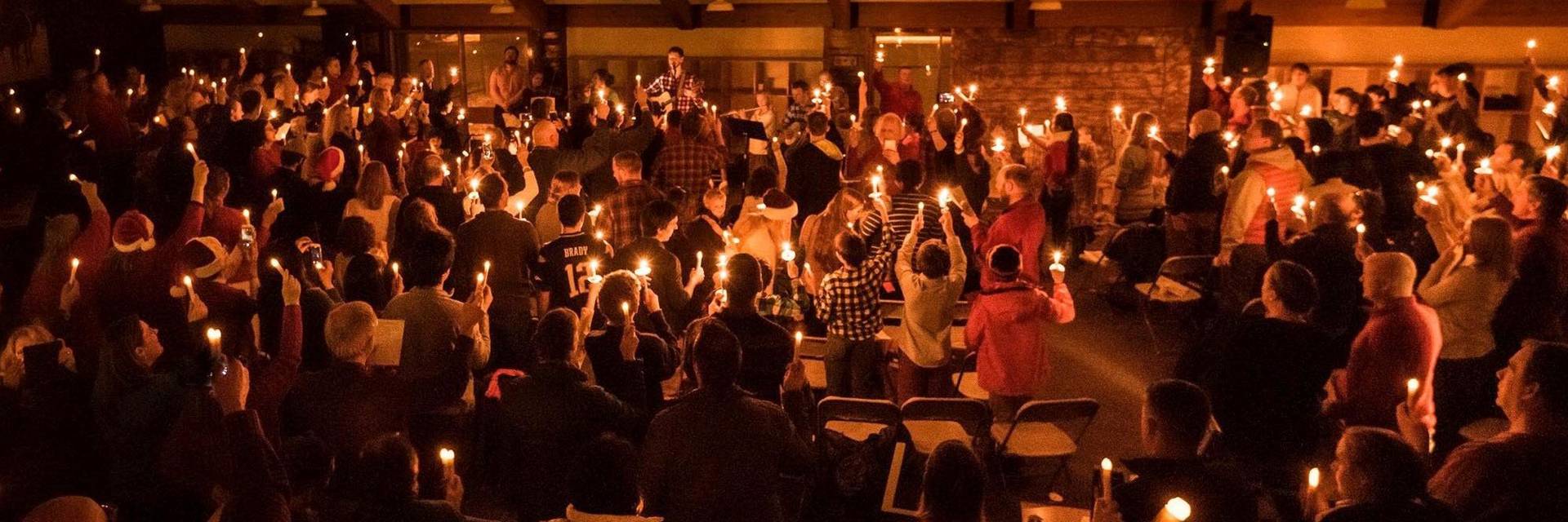 Image of candle centerpiece, decorated in winter greenery