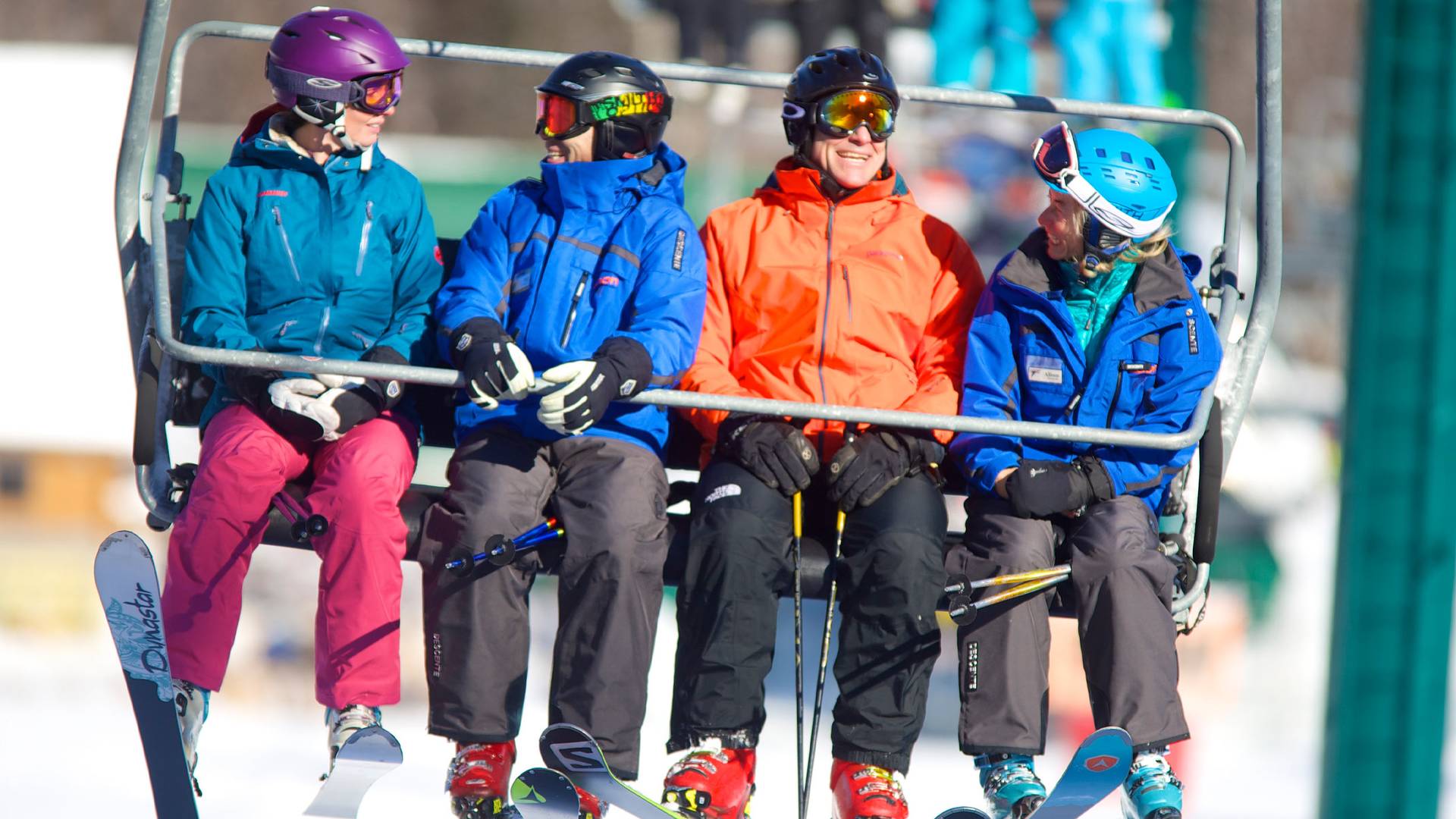 students riding a lift with instructors