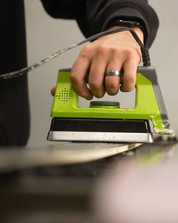 hot wax being applied to ski bottom