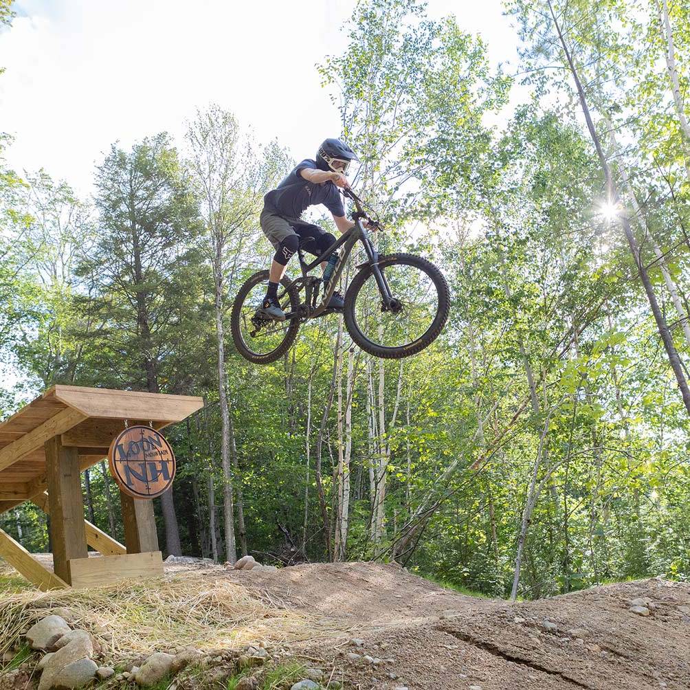 advanced downhill mountain bike rider going off jump