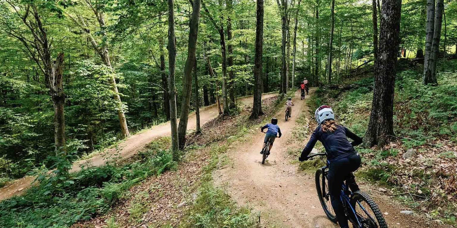 Downhill mountain biker riding a berm in Loon Bike Park