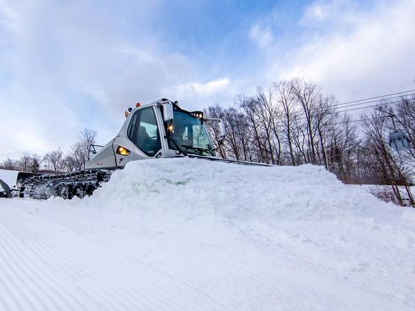 Snow cat grooming the ski trail.