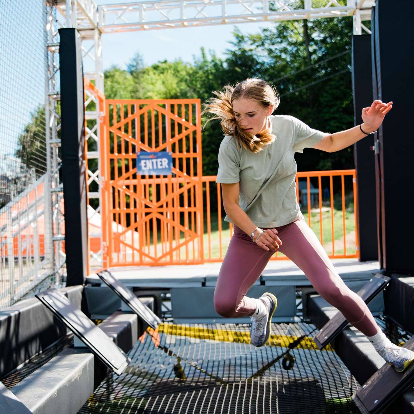 Woman navigating the ninja wild obstacle course