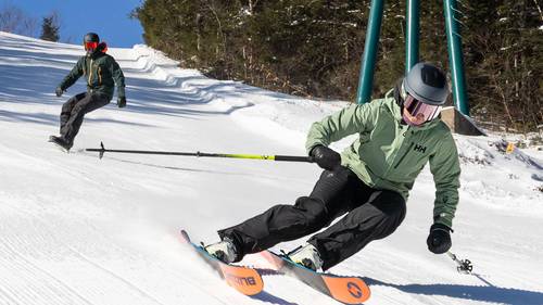Man in red jacked skiing deep powder at Loon Mountain Resort