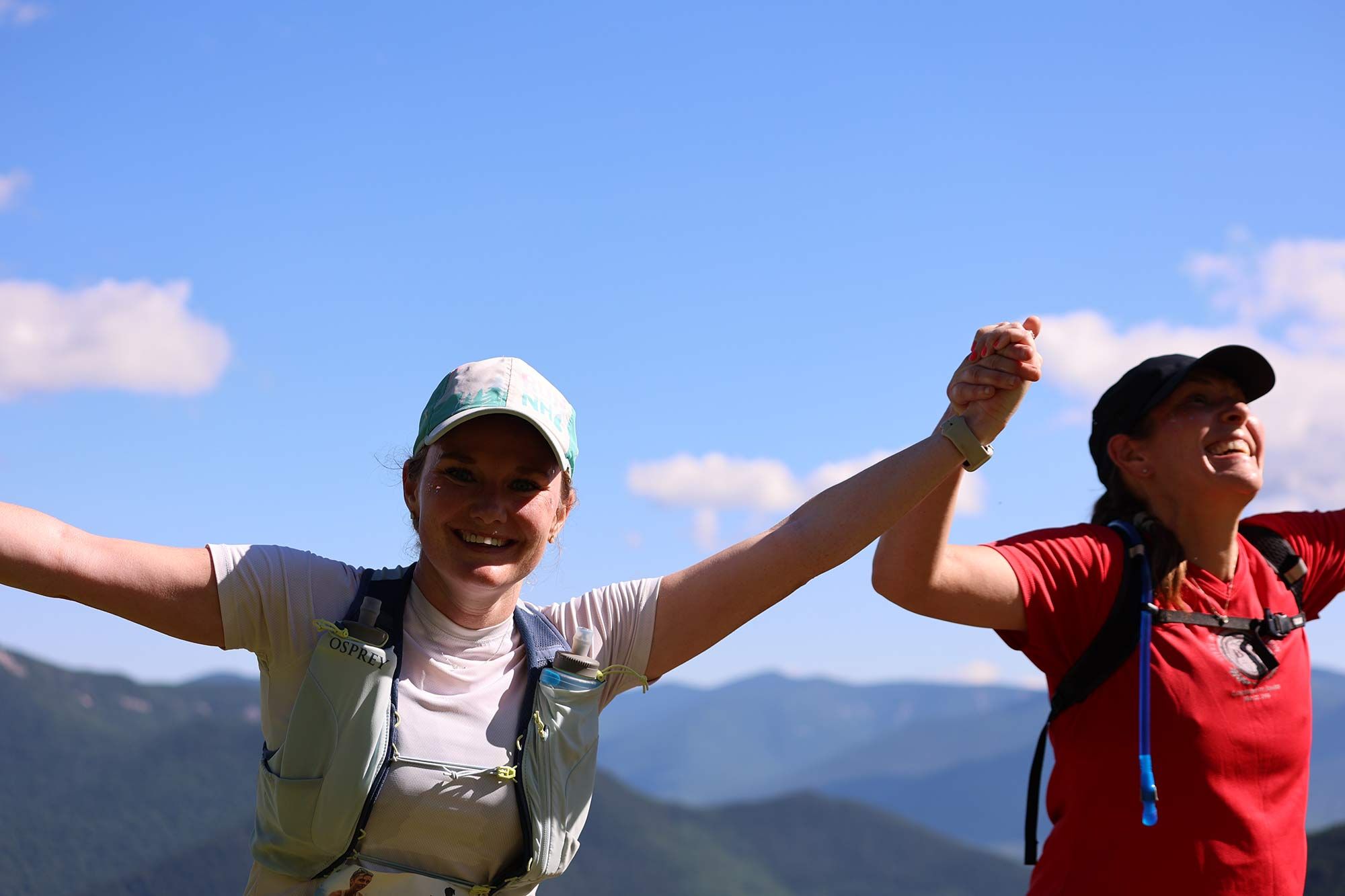 two women holding hands celebrating their run