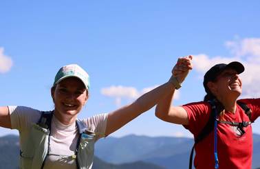 two women holding hands celebrating their run