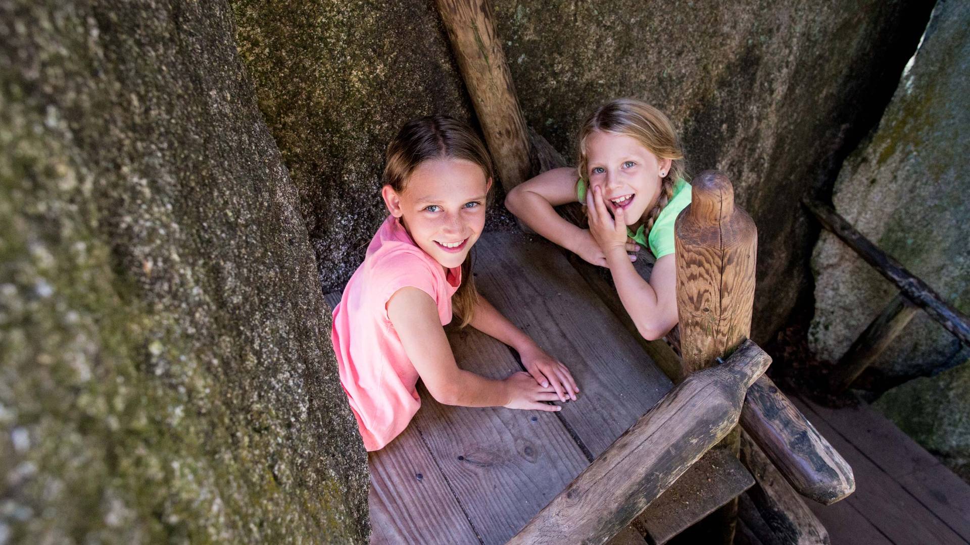 Image of two young girls on a platform in the caves