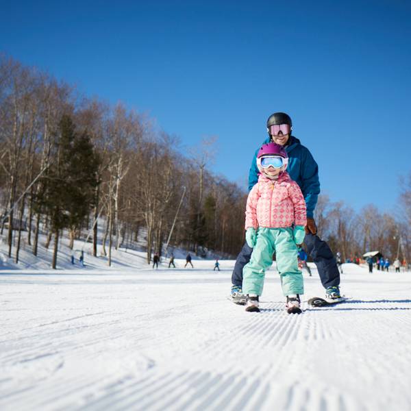 a father and daughter skiing down Sarsaparilla together