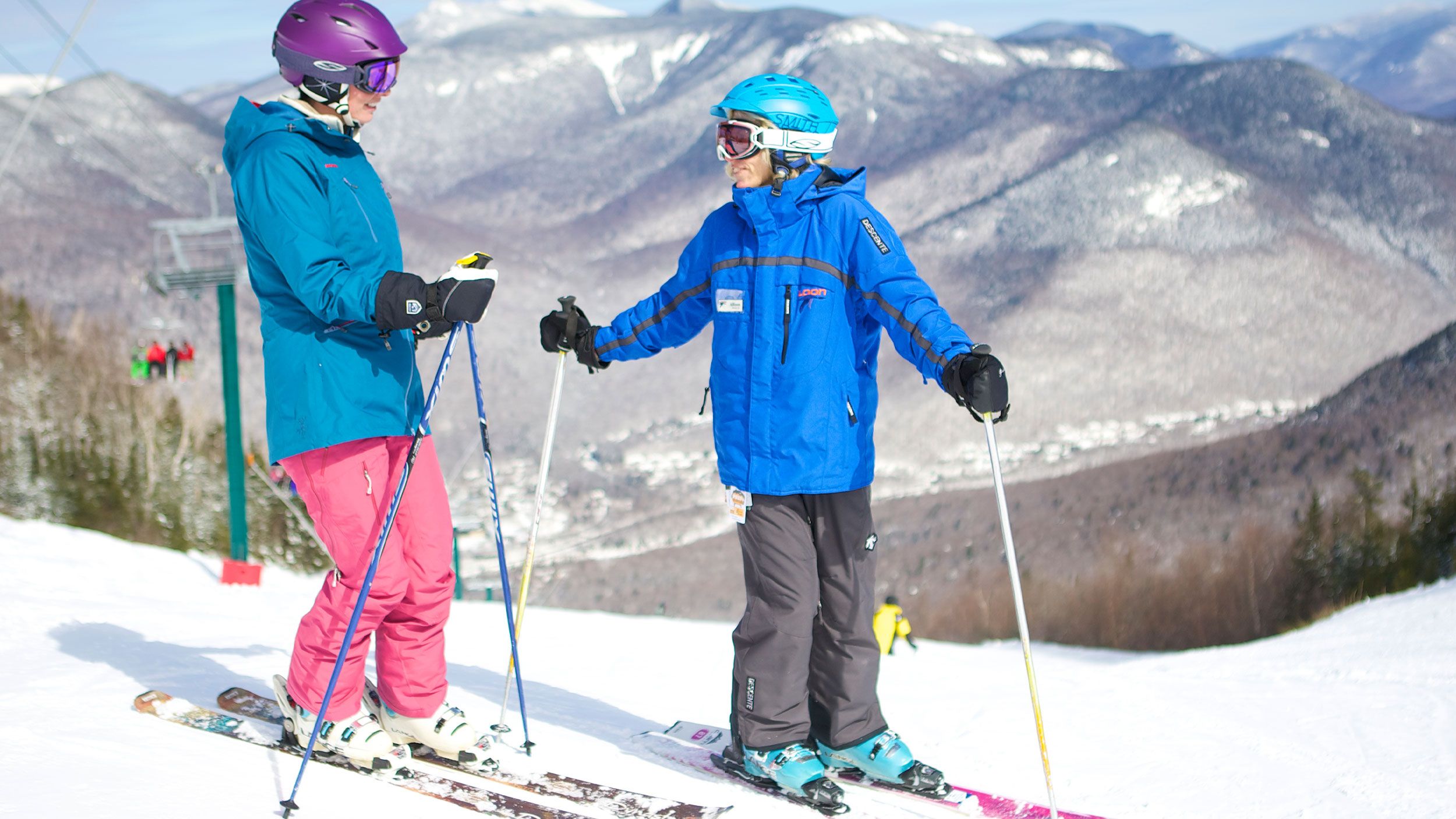 two skiers at the summit of Loon Peak