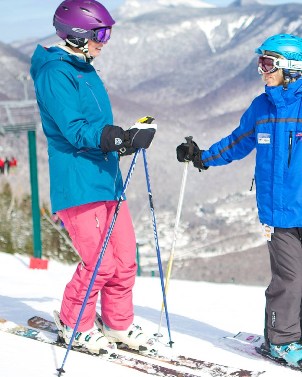 two skiers at the summit of Loon Peak