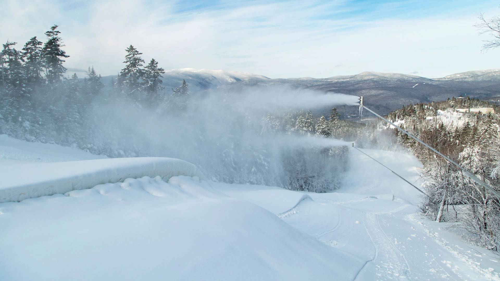 winter snowmaking guns blowing snow on a trail at Loon Mountain