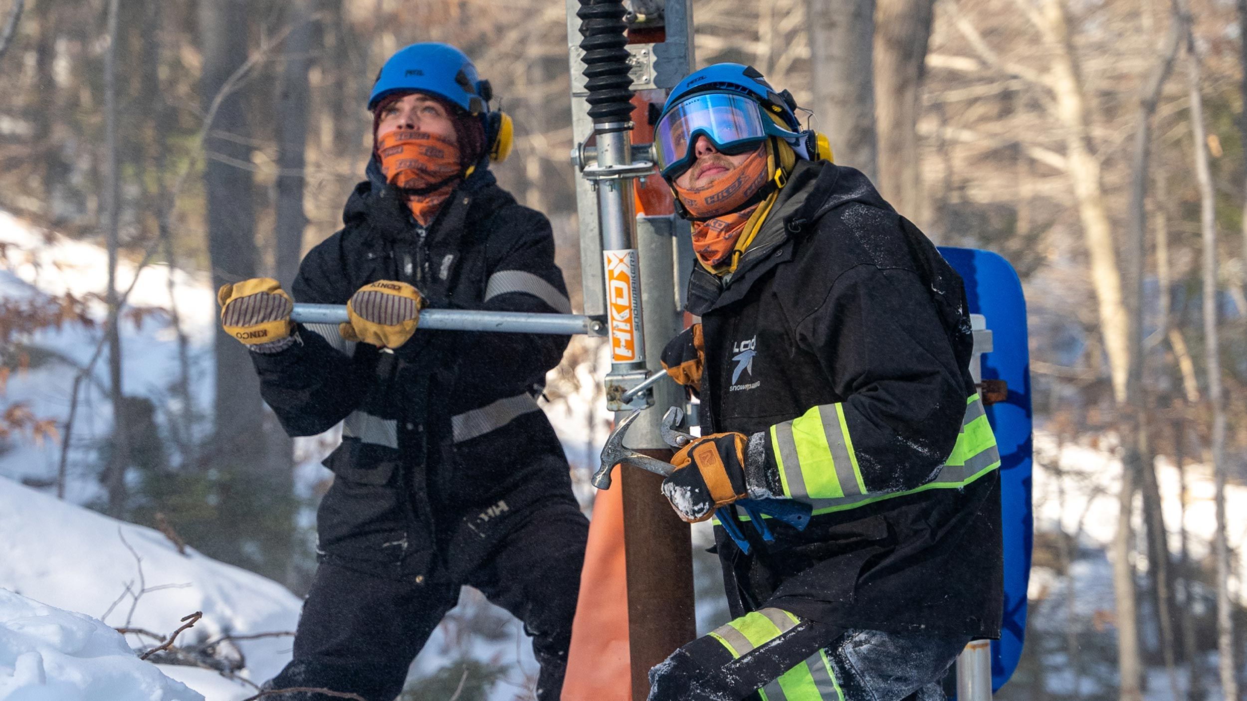 Two snowmakers working at an HKD hydrant
