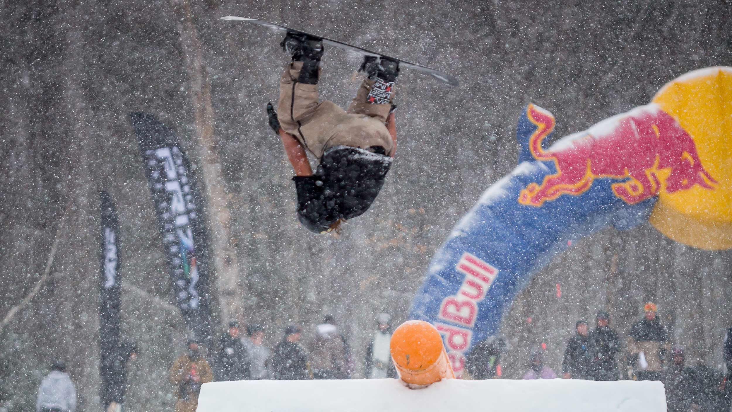 male snowboarder flipping upside down