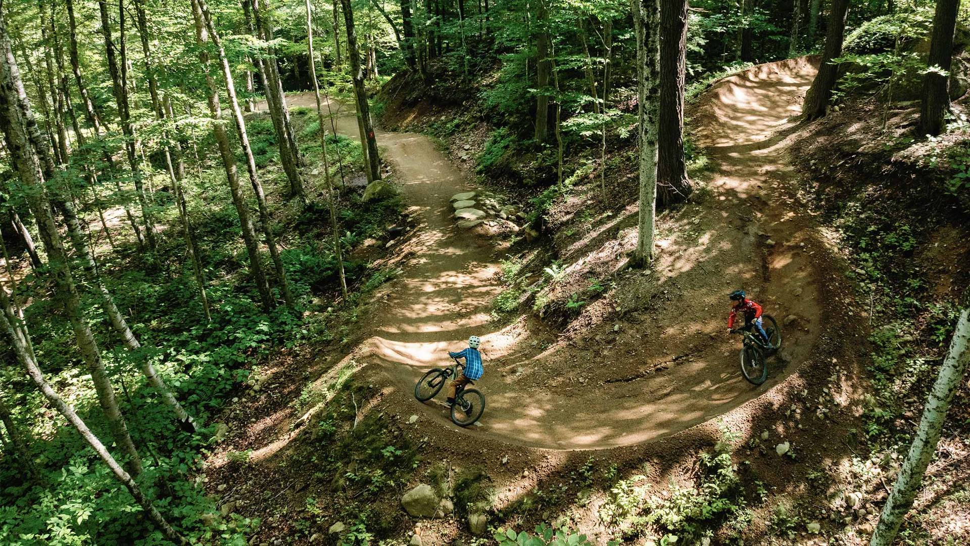 drone image of 2 bikers on a berm