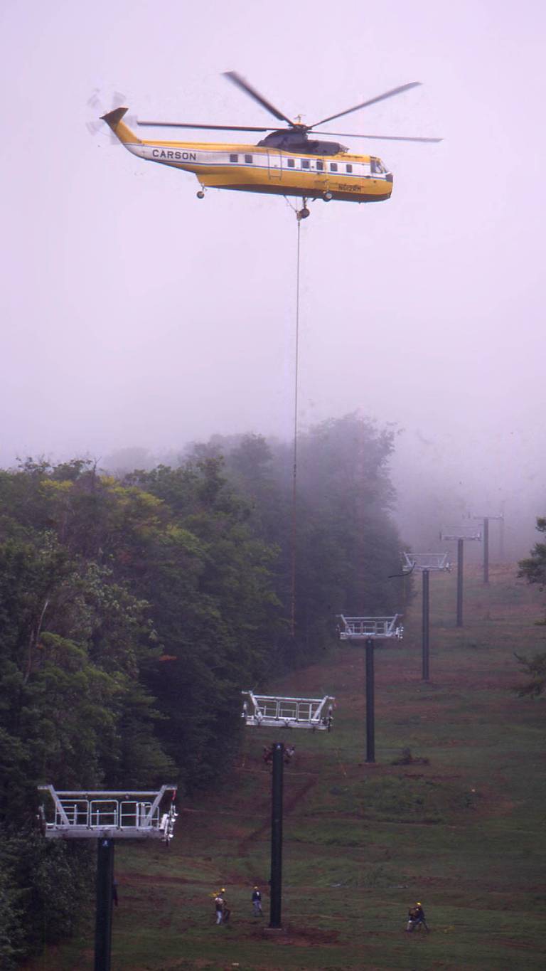 Helicopter flying new chairlift towers in the West Basin