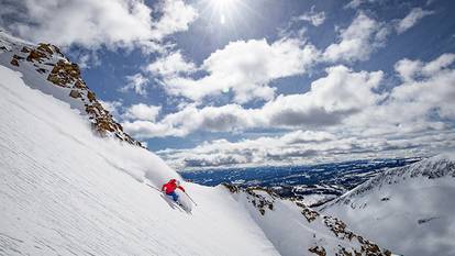 Lodging guests sitting by cozy fire in lodge