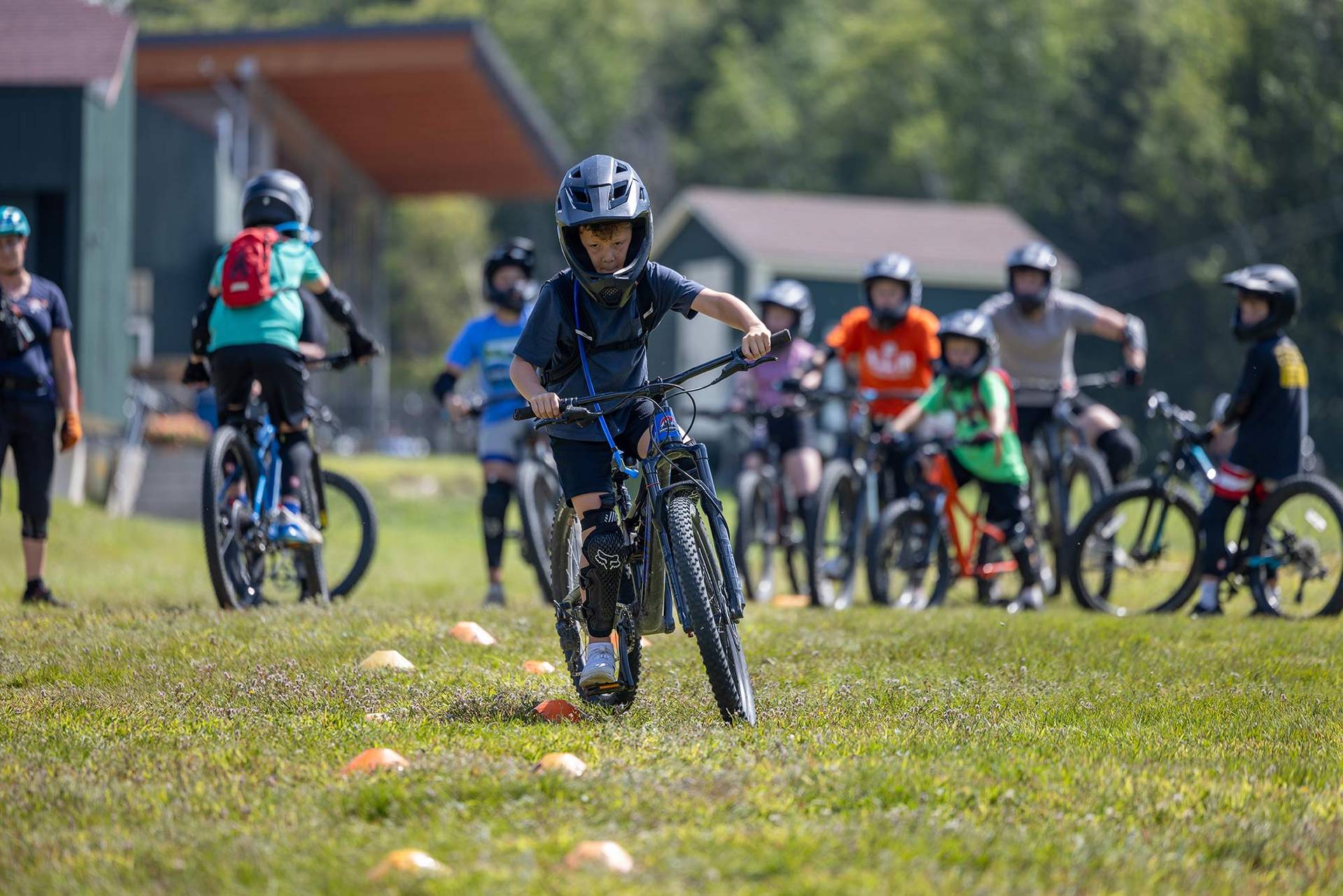 bike camper riding through a skills drill