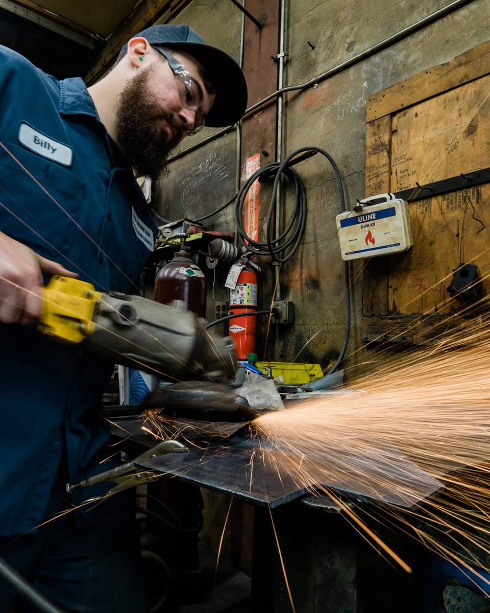Mechanic using a grinder