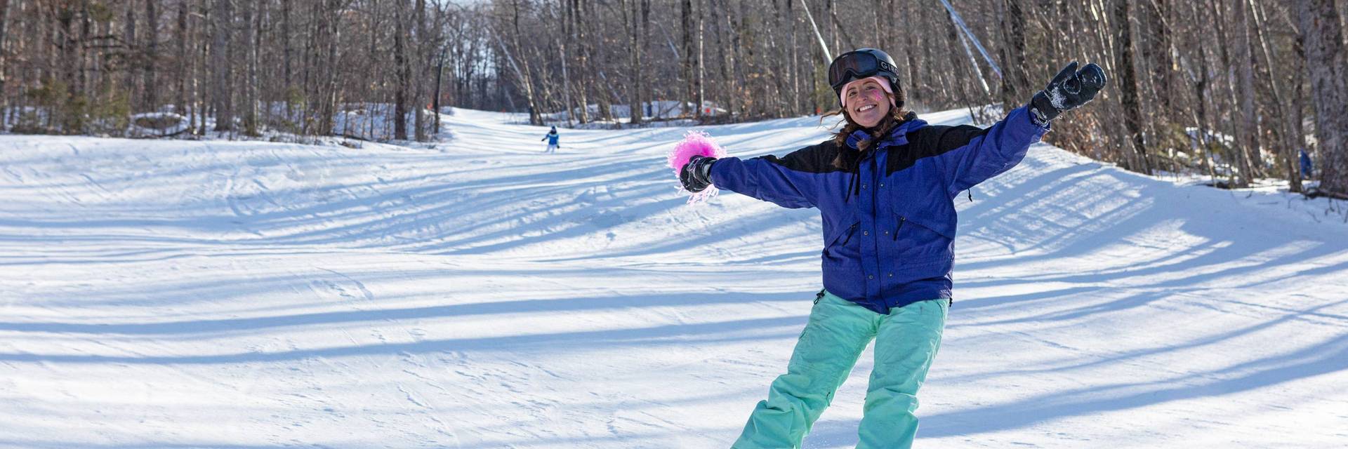 Girl Snowboarding with Pink pom pom