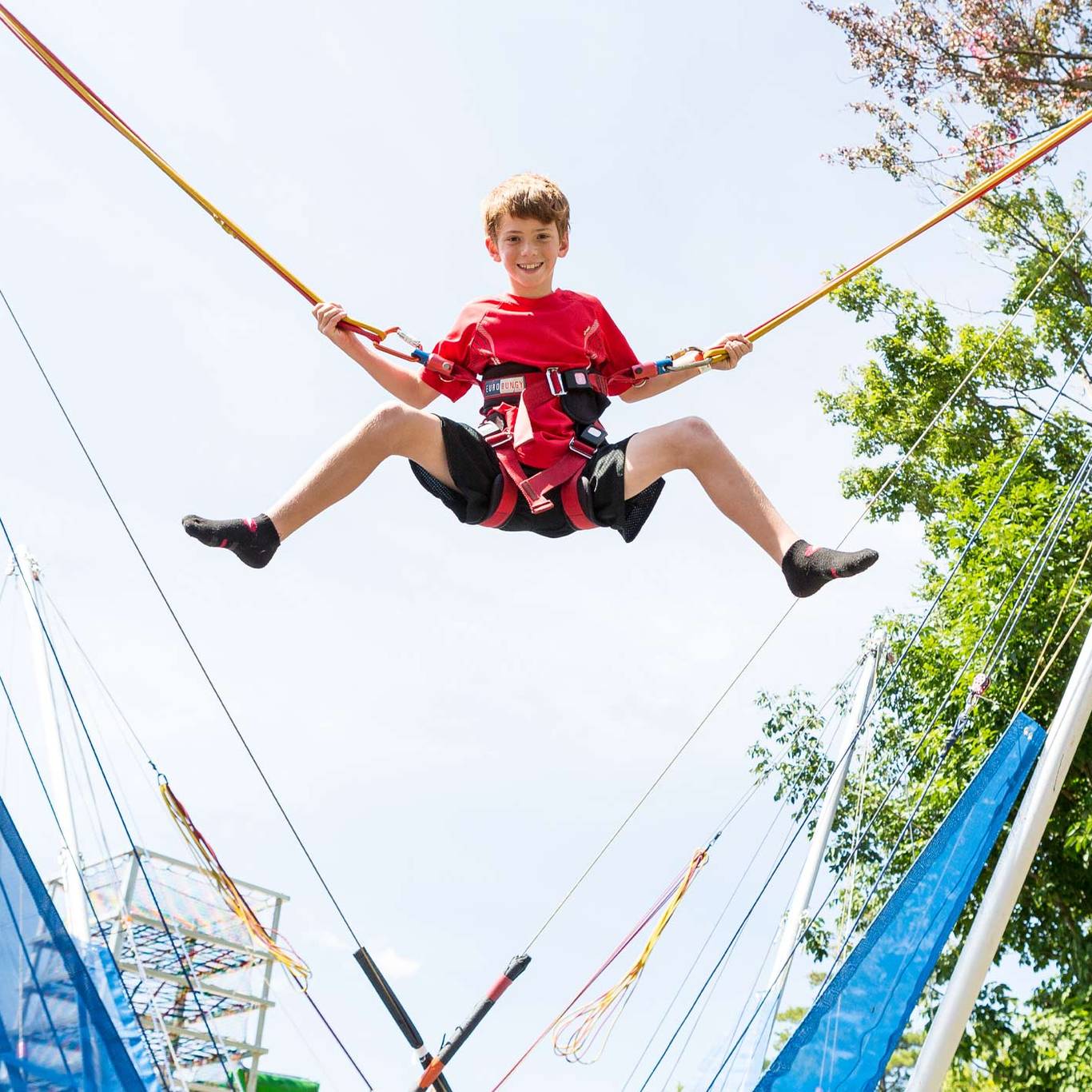 boy bouncing on the bungee trampoline