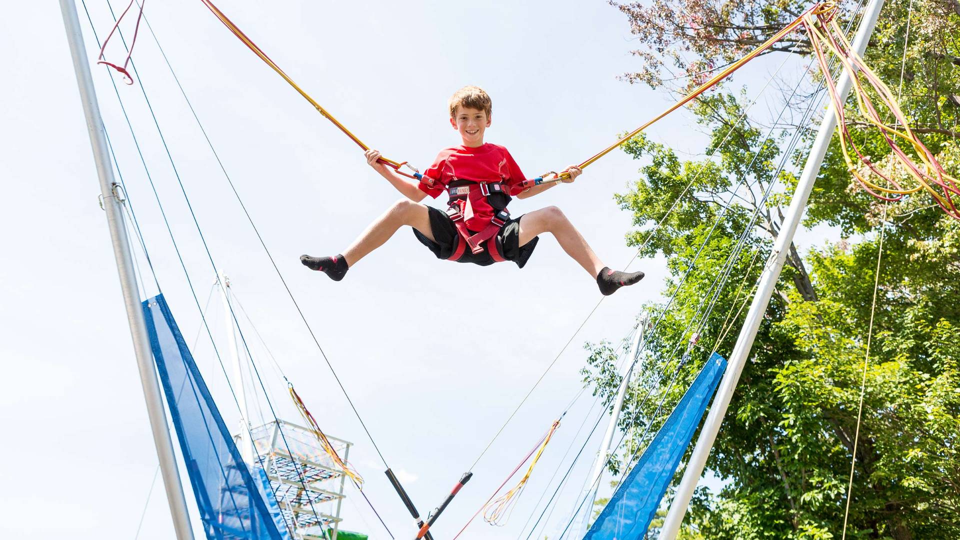 boy doing bungee trampoline