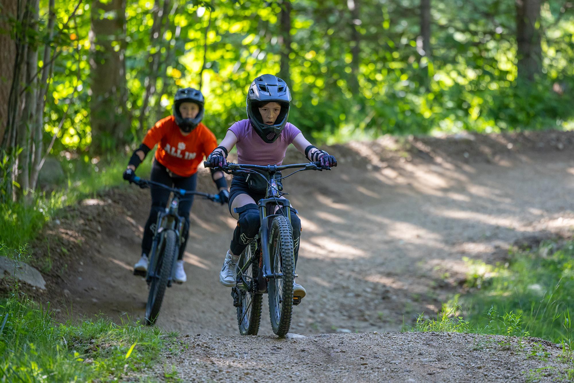 two boys riding downhill trail in Loon Bike Park