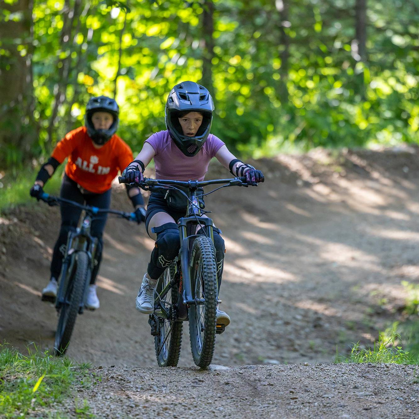 two boys riding downhill trail in Loon Bike Park