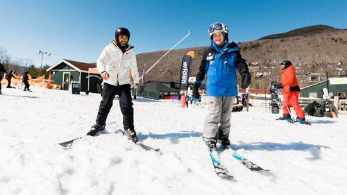 Man receiving a ski lesson from a Loon Mountain ski instructor