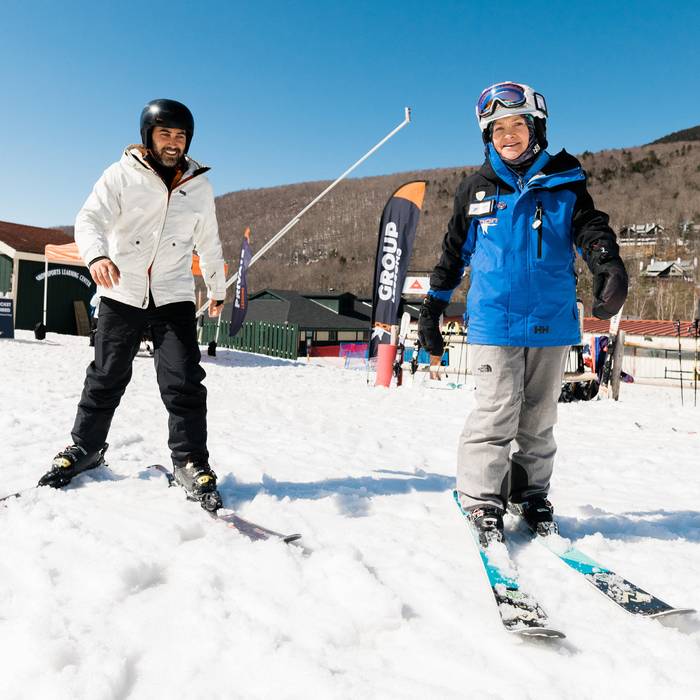 Man receiving a ski lesson from a Loon Mountain ski instructor