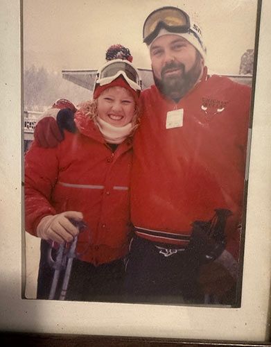 young couple in red jackets smiling at the camera